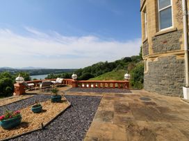 An outdoor patio area with plants and furniture at Apartment 1, Bryn Mel Manor in Menai Bridge