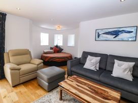 A living room with a round bed and sofa at Apartment 1, Bryn Mel Manor Menai Bridge