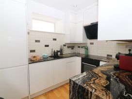 A kitchen with cabinets and a countertop at Apartment 1, Bryn Mel Manor in Menai Bridge