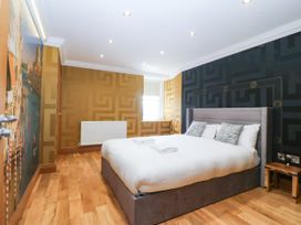 A bedroom with a bed and window at Apartment 1, Bryn Mel Manor in Menai Bridge