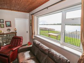 A living room with a view of the lake at Sweetbriar Lodge Castlerea
