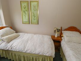 A bedroom with two single beds and wall art at Sweetbriar Lodge in Castlerea