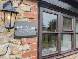 Cider Cottage sign with lamp and window at Cider Cottage in Hawkchurch