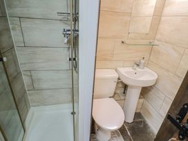 A bathroom with a shower, toilet, and sink at Cider Cottage in Hawkchurch