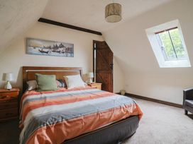 A bedroom with a bed and bedside tables at Cider Cottage in Hawkchurch