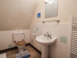 A bathroom with a toilet and sink at Cider Cottage in Hawkchurch