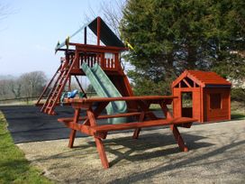 A playset with slide and picnic table at Cider Cottage in Hawkchurch