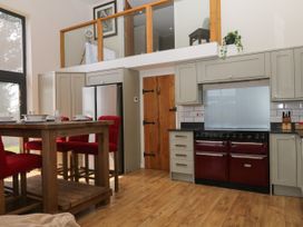 A kitchen with a table and chairs at Fieldstone Barn North Tawton