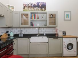 A kitchen with cabinets and a sink at Fieldstone Barn North Tawton