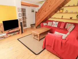 A living room with a sofa and coffee table at 1 Rosemount Garden Villas, Tenby