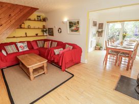 A living room with a sofa and dining area at 1 Rosemount Garden Villas in Tenby
