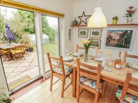 A dining room with a wooden table and chairs at 1 Rosemount Garden Villas Tenby