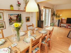 A dining room with a table set for a meal at 1 Rosemount Garden Villas Tenby