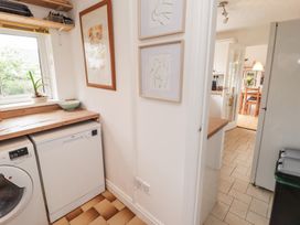 A kitchen with a washing machine and dishwasher at 1 Rosemount Garden Villas Tenby