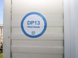 A sign displaying DP13 West Sands at Seaside Retreat in Selsey