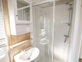 A bathroom with a shower and sink at Seaside Retreat in Selsey