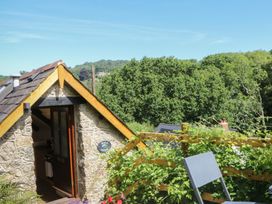 An outdoor area with a door and a chair at The Mill Barn in Lustleigh