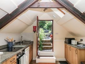 A kitchen with a door leading to a garden at The Mill Barn in Lustleigh
