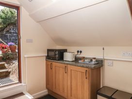 A kitchen with a microwave and toaster at The Mill Barn in Lustleigh