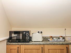 A kitchen with a microwave and toaster at The Mill Barn in Lustleigh