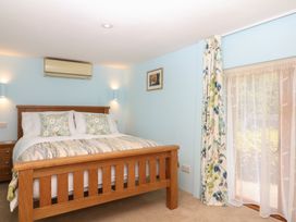 A bedroom with a bed and bedside lamps at The Mill Barn in Lustleigh