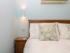 A bedroom with a bed and bedside table at The Mill Barn in Lustleigh