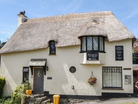 A exterior of a tea room with a thatched roof at The Mill Barn in Lustleigh