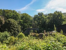 A view of a bridge among trees and plants at The Mill Barn in Lustleigh