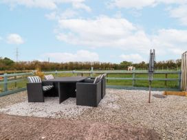 An outdoor seating area with a table and chairs at Moorland View Belowda near Roche