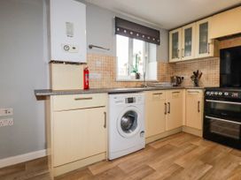 A kitchen with a washing machine and an oven at Moorland View Belowda near Roche