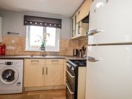 A kitchen with a sink and refrigerator at Moorland View Belowda near Roche