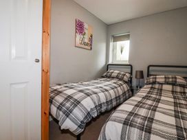 A bedroom with two beds and a window at Moorland View Belowda near Roche