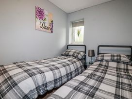 A bedroom with two beds and a window at Moorland View Belowda near Roche