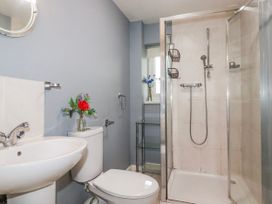 A bathroom with a sink, toilet, and shower at Moorland View Belowda near Roche