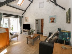 A living room with a sofa and coffee table at Daffodil Cottage in Blaencwm near Treorchy