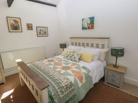 A bedroom with a quilted bed at Daffodil Cottage in Blaencwm near Treorchy
