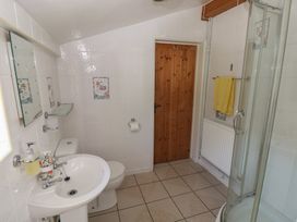 A bathroom with a shower and sink at Daffodil Cottage in Blaencwm near Treorchy