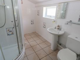 A bathroom with a shower, sink, and toilet at Daffodil Cottage in Blaencwm near Treorchy