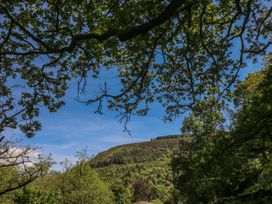 View of trees and a hill under a clear sky at Daffodil Cottage in Blaencwm near Treorchy