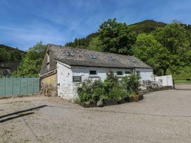 An outdoor view of a cottage with a parking sign at Daffodil Cottage in Blaencwm near Treorchy