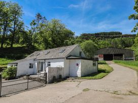 A house and shed with trees in the background at Daffodil Cottage Blaencwm near Treorchy