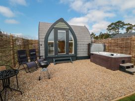 An outdoor area with a hot tub and seating at Cosy Cocoon in Malton