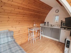 A kitchen area with a table and chairs at Cosy Cocoon in Malton