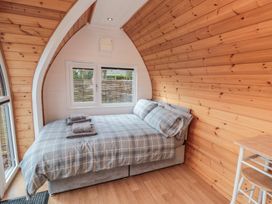 A bedroom with a bed and window at Cosy Cocoon in Malton