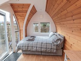 A bedroom with a bed and towels at Cosy Cocoon in Malton
