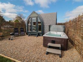 An outdoor area with a hot tub and seating at Cosy Cocoon in Malton