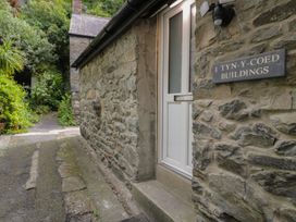 A building entrance with a stone wall and pathway at Llety Cllyd Barmouth