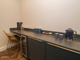 A kitchen with a bar area and beverage items at Llety Cllyd Barmouth