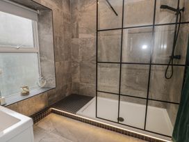 A bathroom with a shower and bathtub at Llety Cllyd in Barmouth