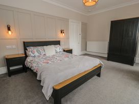 A bedroom with a bed and nightstands at Llety Cllyd in Barmouth